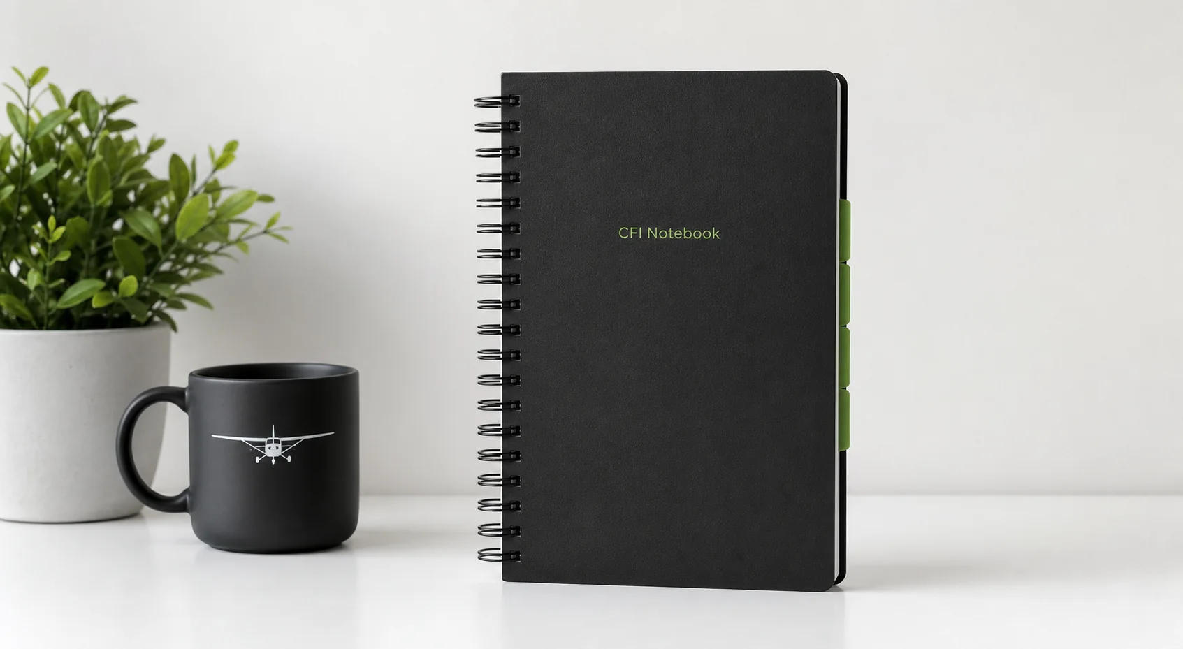 CFI Notebook with an aviation mug and plant